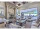Beautifully decorated living room with fireplace and view of the patio area at 13074 E Saddlehorn Trl, Scottsdale, AZ 85259