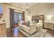 A serene main bedroom featuring hardwood floors, French doors, and a sitting area at 13074 E Saddlehorn Trl, Scottsdale, AZ 85259