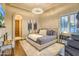 Main bedroom with hardwood floors, elegant chandelier, and neutral decor at 13074 E Saddlehorn Trl, Scottsdale, AZ 85259