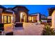 Outdoor living area with a fireplace, comfortable seating, and views of the desert scenery at 13074 E Saddlehorn Trl, Scottsdale, AZ 85259