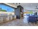 Outdoor living space with a stone fireplace, full kitchen, and lounge seating at 13074 E Saddlehorn Trl, Scottsdale, AZ 85259