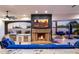 Outdoor living space with stone fireplace, built-in grill, and blue upholstered furniture at 13074 E Saddlehorn Trl, Scottsdale, AZ 85259