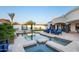 Backyard pool featuring stone accents, lounge chairs, and lush landscaping at 13074 E Saddlehorn Trl, Scottsdale, AZ 85259