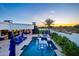 Stunning pool area with a basketball hoop, ample seating, and a view of the desert landscape at 13074 E Saddlehorn Trl, Scottsdale, AZ 85259