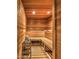Custom sauna featuring wood paneling, built-in seating, and a traditional heater for a relaxing spa experience at 13074 E Saddlehorn Trl, Scottsdale, AZ 85259