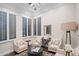 Bright and airy sitting area with shuttered windows and a round table at 13074 E Saddlehorn Trl, Scottsdale, AZ 85259