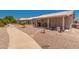 Spacious desert landscaped backyard with covered patio, ideal for outdoor entertaining and relaxation at 1362 E Cherry Hills Dr, Chandler, AZ 85249