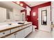 Bathroom with dual sinks, white cabinets and red accent wall at 1362 E Cherry Hills Dr, Chandler, AZ 85249