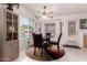 Bright dining area with a modern table set, large windows, and a ceiling fan at 1362 E Cherry Hills Dr, Chandler, AZ 85249