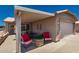 Cozy covered patio featuring comfortable seating and a stone fire pit, perfect for outdoor relaxation at 1362 E Cherry Hills Dr, Chandler, AZ 85249