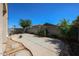 Spacious backyard featuring a concrete patio, block wall, and landscaping at 13959 W Country Gables Dr, Surprise, AZ 85379