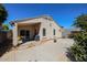 Well-maintained backyard with a covered patio, block wall, and exterior view of the home's architecture at 13959 W Country Gables Dr, Surprise, AZ 85379
