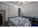Comfortable bedroom with a shark-themed bedspread, closet, and adjoining laundry room at 13959 W Country Gables Dr, Surprise, AZ 85379