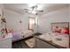 Inviting ' bedroom with comfortable twin beds, neutral walls, and wood-look flooring at 13959 W Country Gables Dr, Surprise, AZ 85379