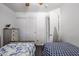 Bright shared bedroom with twin beds, wood-look flooring, and a closet for storage at 13959 W Country Gables Dr, Surprise, AZ 85379
