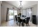 Bright dining area features a glass slider to the backyard and neutral tile flooring at 13959 W Country Gables Dr, Surprise, AZ 85379