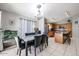 Open-concept dining and kitchen area showcases wood cabinets and a breakfast bar at 13959 W Country Gables Dr, Surprise, AZ 85379