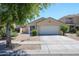 Charming single-level home featuring a two-car garage and well-maintained landscaping at 13959 W Country Gables Dr, Surprise, AZ 85379