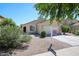 Charming single-level home featuring a two-car garage and well-maintained landscaping at 13959 W Country Gables Dr, Surprise, AZ 85379