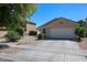 Charming single-level home featuring a two-car garage and well-maintained landscaping at 13959 W Country Gables Dr, Surprise, AZ 85379
