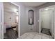 Hallway featuring a statue, tile flooring, and doorways to bedrooms on either side at 13959 W Country Gables Dr, Surprise, AZ 85379