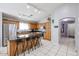 Well-lit kitchen showcasing wood cabinets, granite counters, and an adjacent dining area at 13959 W Country Gables Dr, Surprise, AZ 85379