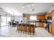 Open kitchen featuring wooden cabinets, granite countertops, and stainless steel appliances at 13959 W Country Gables Dr, Surprise, AZ 85379