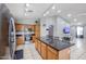 Open kitchen with wood cabinets, granite countertops, and stainless steel appliances at 13959 W Country Gables Dr, Surprise, AZ 85379