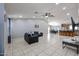 Spacious living room showcasing tile floors, high ceilings, and seamless flow into the dining area at 13959 W Country Gables Dr, Surprise, AZ 85379