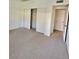 Neutral bedroom featuring a closet with sliding doors, carpet, and natural light at 14002 N 49Th Ave # 1021, Glendale, AZ 85306