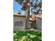 Two-story home features green siding, trimmed windows, and a chimney on a manicured lawn at 14002 N 49Th Ave # 1021, Glendale, AZ 85306