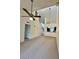 Open-concept living space with high ceilings, ceiling fan, and access to the kitchen at 14002 N 49Th Ave # 1021, Glendale, AZ 85306