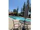 Community swimming pool with tables, chairs, and ample seating under a bright sky at 14002 N 49Th Ave # 1021, Glendale, AZ 85306