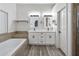 Bathroom featuring double vanity, tile floors, and a soaking tub at 16426 N 49Th St, Scottsdale, AZ 85254