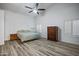 Large bedroom with a ceiling fan and hardwood flooring at 16426 N 49Th St, Scottsdale, AZ 85254