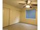 This bedroom has a ceiling fan, closet, and large window providing ample lighting, creating a comfortable space at 16426 N 49Th St, Scottsdale, AZ 85254