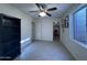 This bedroom features a ceiling fan, a closet, and a window, providing ample lighting and storage at 16426 N 49Th St, Scottsdale, AZ 85254