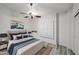 Bedroom featuring a bed with blue accents, shutters, and artwork at 16426 N 49Th St, Scottsdale, AZ 85254