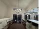 Dining room and eat-in kitchen with hardwood floors and elegant chandeliers at 16426 N 49Th St, Scottsdale, AZ 85254