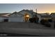 Dusk view of a single-story home featuring desert landscaping and solar panels at 16426 N 49Th St, Scottsdale, AZ 85254