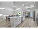 Spacious kitchen with white cabinetry, a large island, and a dining area with an elegant chandelier at 16426 N 49Th St, Scottsdale, AZ 85254