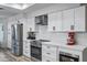 Updated kitchen with stainless steel appliances, white countertops and cabinets, and modern fixtures at 16426 N 49Th St, Scottsdale, AZ 85254
