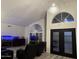 Living room with vaulted ceiling, unique lighting, fish tanks and black leather recliners at 16426 N 49Th St, Scottsdale, AZ 85254