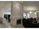 Living room showing fireplace, with views to the dining room, kitchen, and black leather recliners at 16426 N 49Th St, Scottsdale, AZ 85254