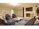 Comfortable living room features plush seating, stylish decor, and a cozy fireplace with large screen television at 16426 N 49Th St, Scottsdale, AZ 85254