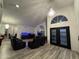 Living room with a vaulted ceiling, elegant lighting, fish tanks and multiple black leather recliners at 16426 N 49Th St, Scottsdale, AZ 85254