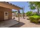Backyard patio area surrounded by desert landscaping and a storage shed at 1858 N 128Th Dr, Avondale, AZ 85392
