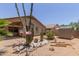 The backyard has desert landscaping with a storage shed and covered patio, perfect for outdoor relaxation at 1858 N 128Th Dr, Avondale, AZ 85392