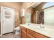 Bathroom with double vanity, tiled shower, and access to backyard at 1858 N 128Th Dr, Avondale, AZ 85392