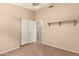 Neutral bedroom featuring neutral walls, closet and tile floors and decorative light fixture at 1858 N 128Th Dr, Avondale, AZ 85392
